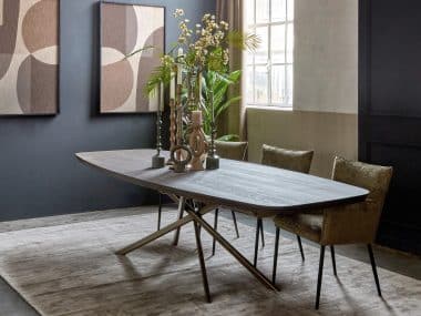 Deens ovale eettafel in een donkere bruine kleur. Massief hout. Met mos groene eetkamerstoelen met armleuning. Sfeervolle afstyling.